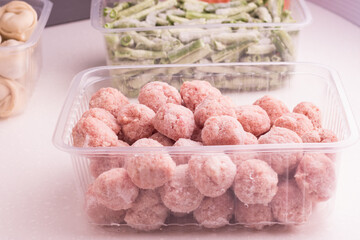 Containers with semi-finished meat products  from the refrigerator. meatballs, dumplings, chopped beans