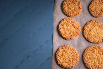 delicious homemade cookies on baking paper on blue wooden background