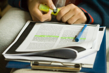Highlighting. Shot of a student highlighting text while studying.