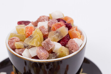 Close up of dried fruits in a black cup.