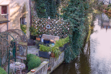 Bruges, Belgium - March 27, 2015 - A small backyard of a private watchmaker with numerous old clocks as decoration
