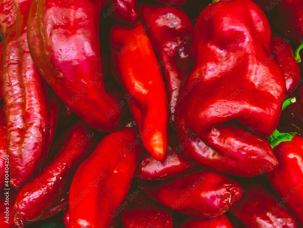 Poster long red pepper with a large twig on the branch. natural texture. background from products. pepper f