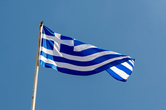 Flag of Greece waving in blue sky