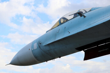 Fototapeta na wymiar Russian military fighter on background of blue sky with white clouds