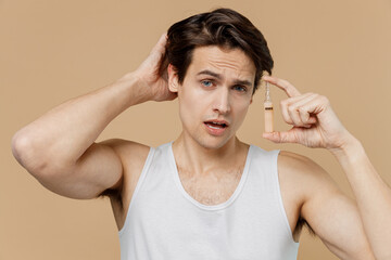 Attractive sexy young man 20s perfect skin in undershirt hold keratin regenerative ampoule isolated...