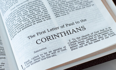 Corinthians open Holy Bible Book close-up. New Testament Scripture. Studying the Word of God Jesus...