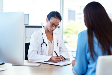Im going to write a referral for you. Shot of a young doctor having a discussion with a patient in...