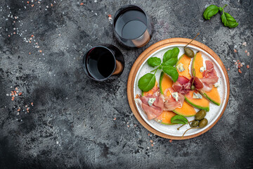 italian food with red wine, melon and prosciutto, Cantaloupe melon with prosciutto or jamon and...