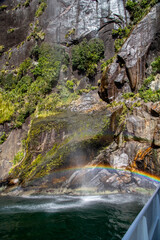 Rainbow from Waterfall in Milford Sound Fiordland National Park New Zealand on a Sunny Spring Day