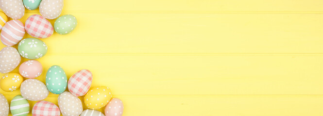 Easter double border with modern farmhouse cloth and pastel eggs over a yellow wood banner background. Overhead view with copy space.