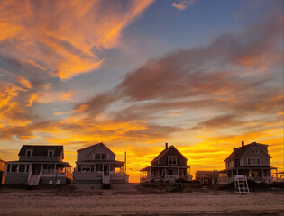 Fototapeta na wymiar Summer cottages on the beach at sunset