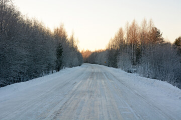 Fototapeta premium Frozen road in Karelia and majestic winter forest