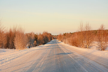 Obraz premium Frozen road in Karelia and majestic winter forest