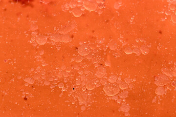 Background image of some bubbles in an orange substance