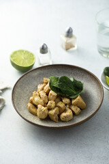 Baked chicken meat with spinach and lime