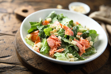 Traditional Caesar salad with salmon