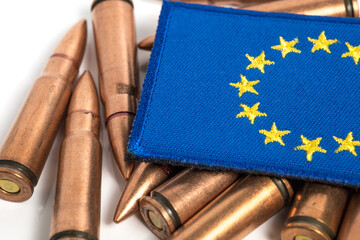 Closeup of EU flag with weapon ammunition. EU delivery of weapons and ammo  to Ukraine. Military...