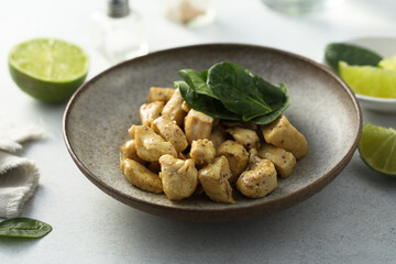 Baked chicken meat with spinach and lime