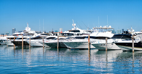 Sea water reflecting sunlight at luxury motor yacht boats in South Beach, USA