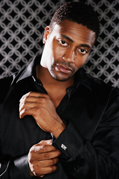 Portrait of African man fixing cufflink