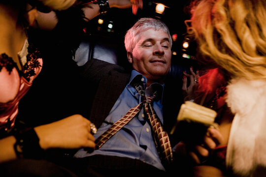 Middle-aged man with prostitutes