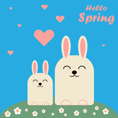 Two cute bunnies on the lawn with flowers