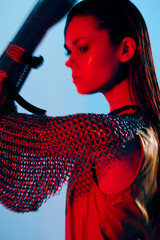 photo pretty woman red light silver armor chain mail fashion blue background