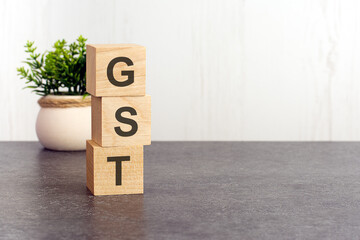 word GST made with wood building blocks