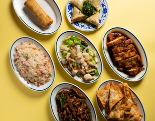 Typical Chinese food on yellow background