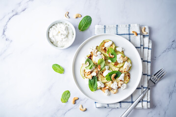 Zucchini ricotta cashew mint salad in a plate