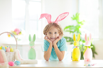 Kids on Easter egg hunt. Children dye eggs.