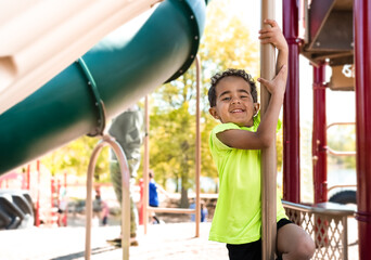 Portrait of smiling African American boy on playground in Midwest in spring