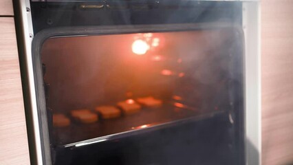 Unrecognizable Man Opens an Oven Full of Smoke in the Kitchen. Male Bachelor Ruined Dinner with Burnt Food. Bad Cook. 