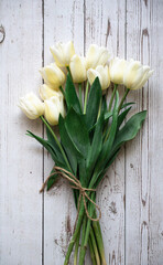 Flatlay of tulips on the wooden background.