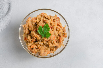 Top view of traditional Balkan dish Kiopoolu, eggplant based spread in a glass bowl on grey background