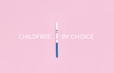 Pregnancy test with negative result and phrase Childfree by choice on pink background....