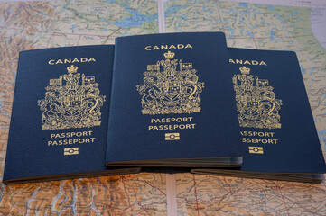 Photo of a Canadian passports against map of Canada.