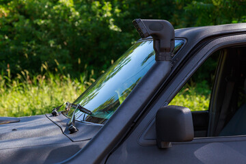 Snorkel or exhaust pipe of a 4x4 off-road vehicle. Background with copy space © Iurii Gagarin