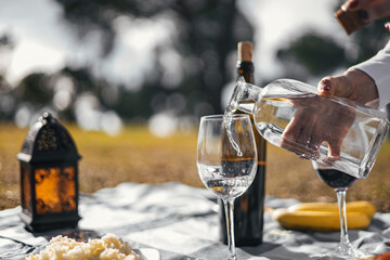 close-up view of woman hand serving water in a picnic