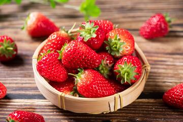 Fresh juicy strawberry in bamboo basket on wooden table. fruit Strawberry.