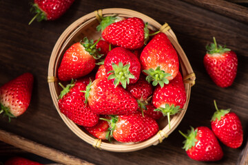 Fresh juicy strawberry in bamboo basket on wooden table. fruit Strawberry.