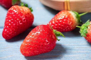 Fresh juicystrawberry on blue wooden table.