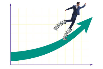Businessman jumping high on springs