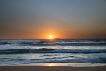 Sun, sand, ship sunrise seascape