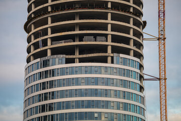Facade of residential or business multi-story building skyscraper under construction. Building...