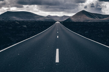 Endless road on a volcano in Timanfaya National Park in Lanzarote in the Canary Islands with a...