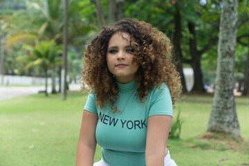 happy white curly haired teenager outdoors