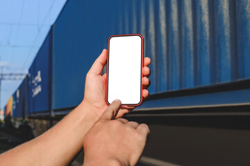 Smartphone mockup in male hand. Against the background of a railway car in motion.