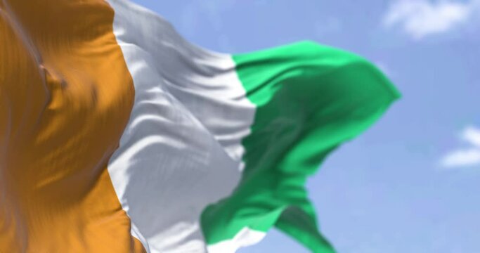 Detail of the national flag of Ivory Coast waving in the wind on a clear day