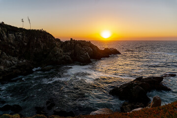 Fototapeta na wymiar rocks in a sunset by the sea in the park 
